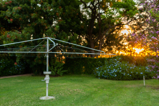 Out of focus scene of country backyard with washing line at sunset in Australia