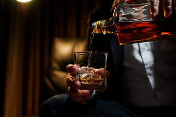 Closeup businessmen holding a glass of whiskey