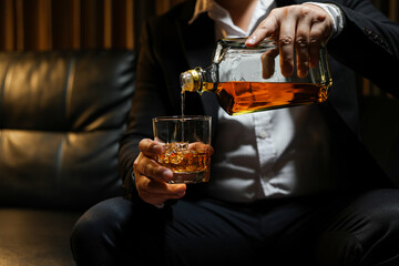 Closeup businessmen holding a glass of whiskey