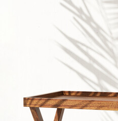 Wood rectangle pedestal side table tray raised edge podium in sunlight, tropical palm tree leaf shadow on white cement wall. Luxury organic cosmetic, skincare, body care, beauty product background 3D