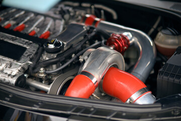 Under the hood of a sports car. Powerful engine close-up. Clean the engine block.