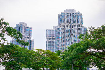 Obraz na płótnie Canvas Apartment building in Malaysia with green trees