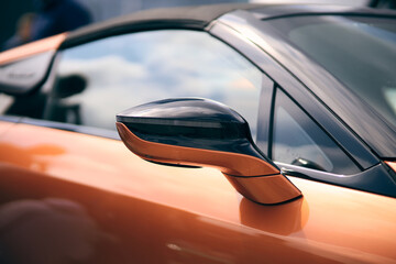 Orange tuned sports luxury car fragment. Sport car at the start.