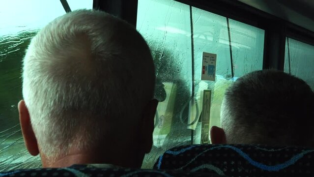 People ride the bus in the rain