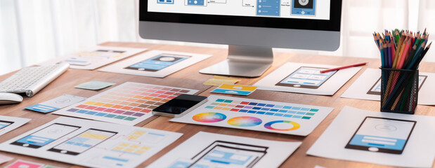 Digital and paper wireframe designs for web or mobile app UI UX display on laptop computer screen....