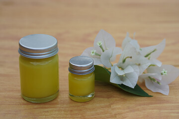 Obraz na płótnie Canvas Bottles of homemade Thai herbal ointment. Concept, Thai local wisdom to use fragrant medicinal herbs to make inhaler and massage balm. 