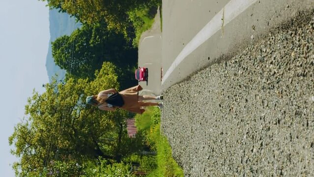 Vertical tourist walks along a hot highway under the scorching rays of the sun