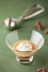 Ice cream ball with irish coffee liqueur. Alcoholic affogato. Summer cocktail.