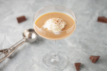 Ice cream ball with irish coffee liqueur. Alcoholic affogato. Summer cocktail.