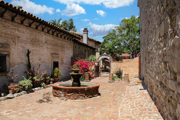 A beautiful small courtyard at San Juan Capistrano mission - obrazy, fototapety, plakaty