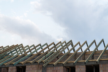 Residential construction site of terraced house or row homes. Roof truss wooden framework,...