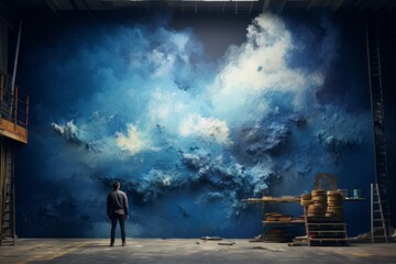 Artist painting blue color and clouds in a wall. Artist and freedom concept.