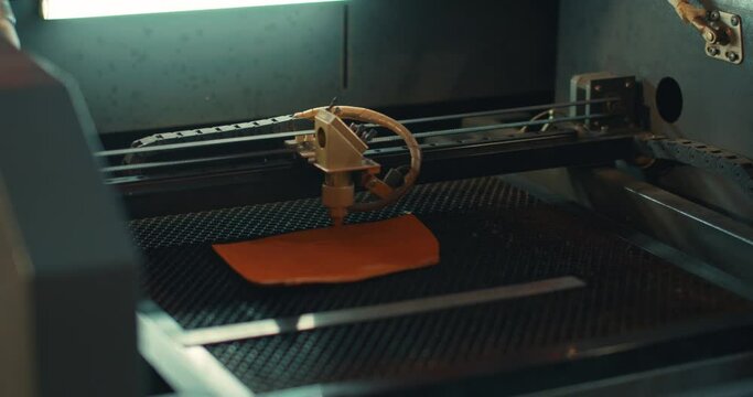 man in glasses testing new engraving machine, Modern machine industrial technology of artificial leather cutting. Masterclass, workshop session
