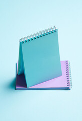 Two notebooks on blue pastel background. Minimalism. Creative layout
