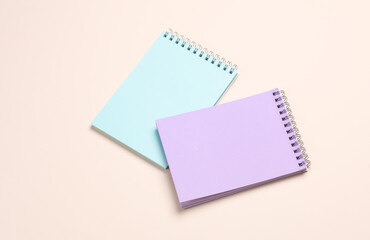 Two notebooks on beige pastel background. Minimalism. Creative layout