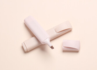 Markers or colored felt-tip pens on beige pastel background. Creative layout