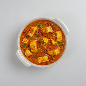 Spicy paneer tikka masala in white bowl on whtite background , image