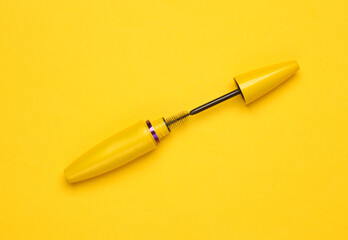 Fototapeta premium Mascara brush on a yellow background. Beauty concept