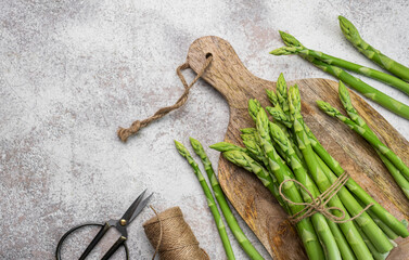 Fresh green asparagus on  concrete background.