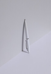 White pen on a white background with shadow. Creative layout. Minimal business concept. Conceptual still life
