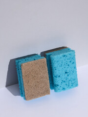 Two cleaning sponges on white background with shadow. Minimalism