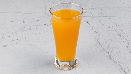 fresh orange juice in glass on textured white background 