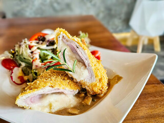 Cordon Bleu Schnitzel,Chicken Cordon Bleu is thin tenderised meat, filled with cheese and ham, coated in breadcrumbs and fried to crisp with Creamy mushroom sauce.