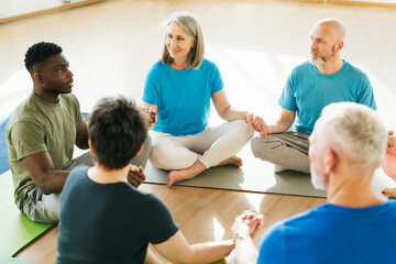 Fototapeta premium Group of mature friends laughing from funny stories after yoga
