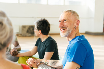 Group of mature friends laughing from funny stories after yoga