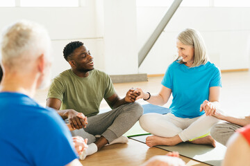 Group of mature friends laughing from funny stories after yoga
