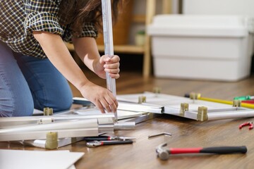Asian Woman self repairs furniture renovation using equipment to diy repairing furniture sitting on...