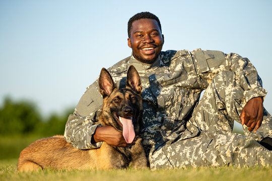 Portrait of brave soldier and his trained military dog.