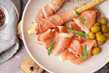 Plate with slices of tasty jamon on table, closeup