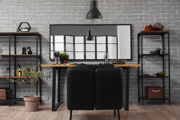 Modern hairdresser workplace near grey brick wall in salon