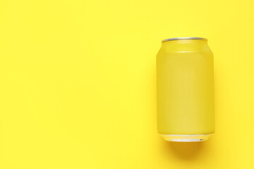 Can of soda on yellow background