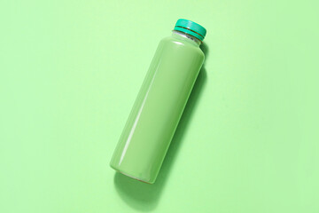 Bottle of fresh soda on green background