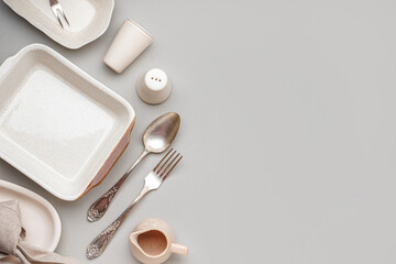 Set of stylish tableware on grey background