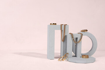 Decorative podiums with beautiful jewelry on white background