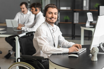 Male technical support agent with physical disability working in office