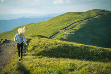 Fototapeta na wymiar Young Skinny Girl Running into Carpathian Mountains