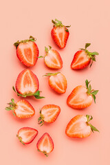 Slices of fresh strawberries on pink background
