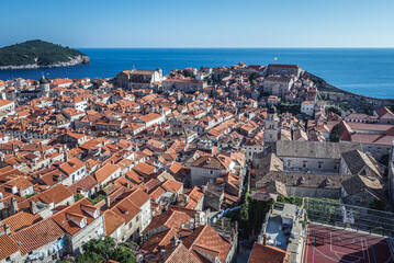Fototapeta na wymiar Aerial view from walls in Old Town of Dubrovnik city, Lokrum island on background, Croatia