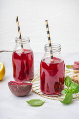 Bottles of fresh beetroot juice on white background