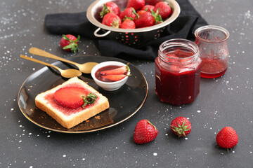 Plate of tasty toast with sweet strawberry jam and fresh berries on grunge background
