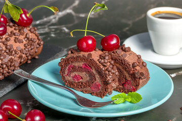 Chocolate roll cake with cream and cherries.