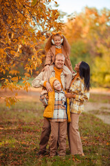 Fototapeta premium family traditions. multiethnic family spending leisure time in autumn in the park