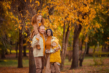 family traditions. multiethnic family spending leisure time in autumn in the park