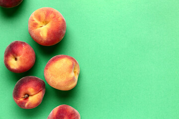 Sweet peaches on green background