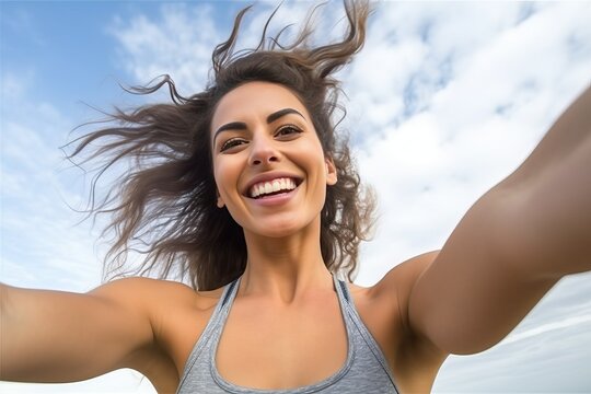Fitness woman taking fun selfie against the sky.