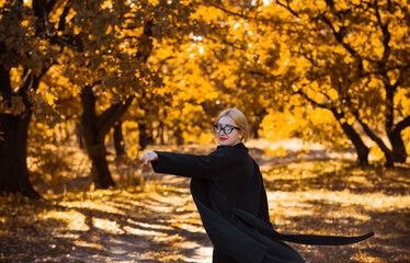 Outdoor atmospheric lifestyle portrait of young beautiful European mixed race lady. Warm autumn